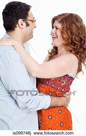 Stock Image - Couple embracing against white background. Fotosearch