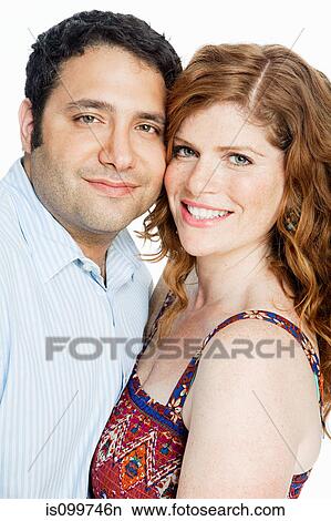 Couple smiling against white background View Large Photo Image Picture - Couple smiling against white background. Fotosearch