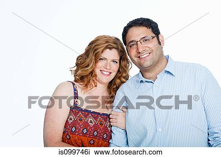Couple smiling against white background View Large Photo Image Stock Image - Couple smiling against white background. Fotosearch