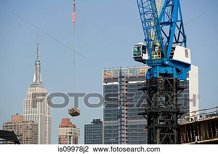 Crane lifting construction material over New York View Large Photo Image Stock Image - Crane lifting construction material over New York. Fotosearch