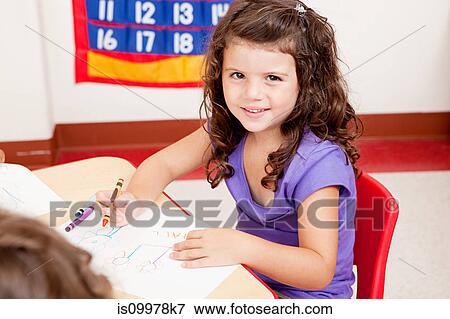 Girl drawing a picture in class View Large Photo Image Stock Photo - Girl drawing a picture in class. Fotosearch