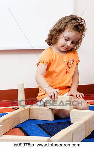 Girl playing with building blocks View Large Photo Image Stock Photography - Girl playing with building blocks. Fotosearch