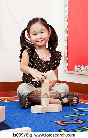 Girl playing with building blocks View Large Photo Image Stock Photography - Girl playing with building blocks. Fotosearch