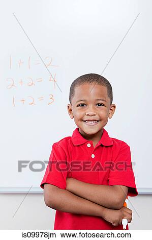Happy schoolboy in front of mathematics on whiteboard View Large Photo Image Picture - Happy schoolboy in front of mathematics on whiteboard. Fotosearch