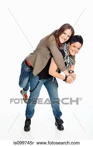 Stock Photography - Lesbian couple standing against white background. Fotosearch