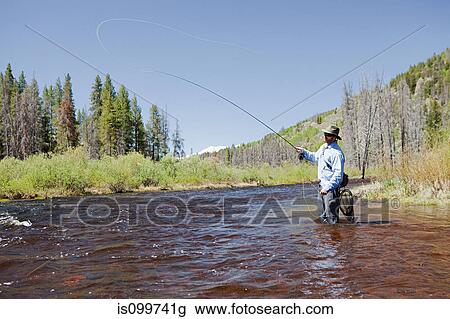 Stock Image - Man fly fishing in river, Colorado, USA. Fotosearch