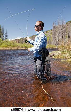 Man fly fishing in river, Colorado, USA View Large Photo Image Stock Image - Man fly fishing in river, Colorado, USA. Fotosearch