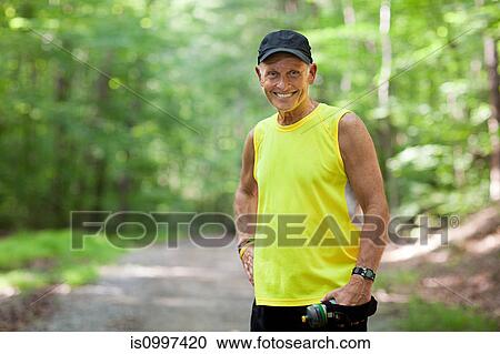 Stock Image - Man resting during exercise, portrait. Fotosearch
