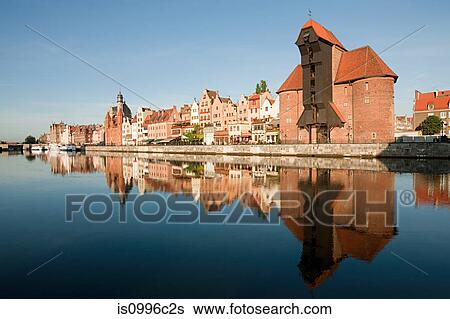Stock Photograph - Medieval buildings reflected in water, Gdansk, Poland. Fotosearch