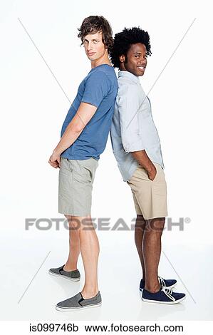 Stock Image - Men leaning together against white background. Fotosearch