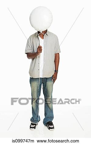 Mid adult man holding balloon against white background View Large Photo Image Picture - Mid adult man holding balloon against white background. Fotosearch