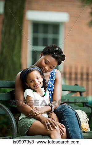 Mother and daughter relaxing in park View Large Photo Image Stock Photo - Mother and daughter relaxing in park. Fotosearch