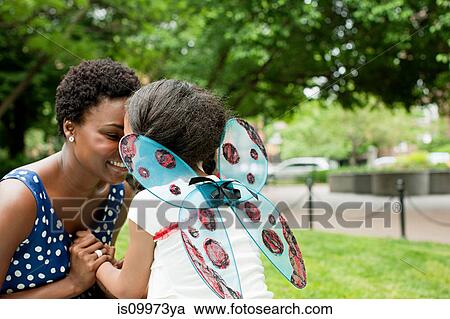 Stock Image - Mother and daughter together in park. Fotosearch