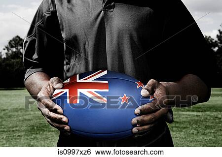 Player holding rugby ball with New Zealand flag View Large Photo Image Stock Photograph - Player holding rugby ball with New Zealand flag. Fotosearch