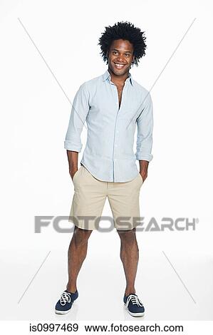 Portrait of young man against white background View Large Photo Image Stock Photo - Portrait of young man against white background. Fotosearch