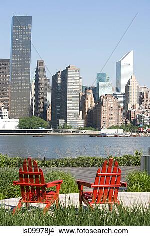 Red deckchairs overlooking East River towards Manhattan, New York View Large Photo Image Picture - Red deckchairs overlooking East River towards Manhattan, New York. Fotosearch