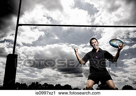 Rugby player with world on rugby ball View Large Photo Image Stock Image - Rugby player with world on rugby ball. Fotosearch