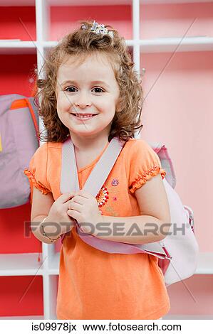 Stock Photo - Schoolgirl wearing backpack. Fotosearch