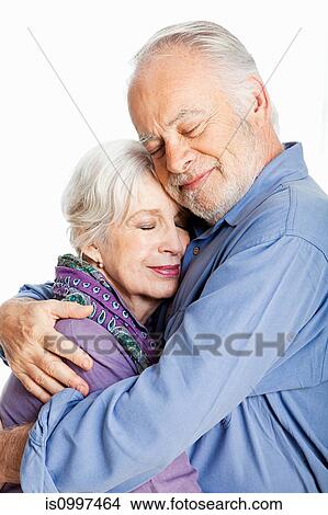 Senior couple embracing against white background View Large Photo Image Picture - Senior couple embracing against white background. Fotosearch