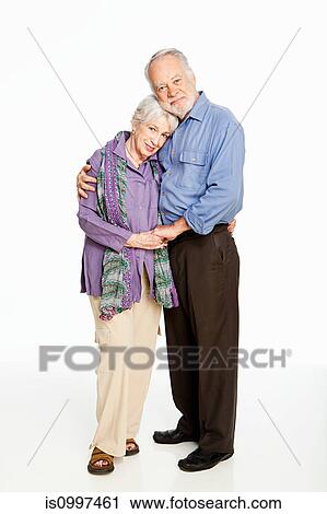 Senior couple embracing against white background View Large Photo Image Stock Image - Senior couple embracing against white background. Fotosearch