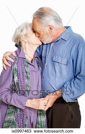 Senior couple kissing against white background View Large Photo Image Stock Image - Senior couple kissing against white background. Fotosearch