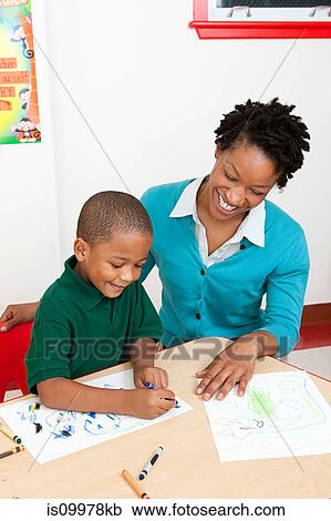 Teacher and boy drawing a picture View Large Photo Image Stock Image - Teacher and boy drawing a picture. Fotosearch