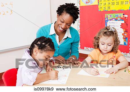 Teacher and girls in art class View Large Photo Image Stock Photo - Teacher and girls in art class. Fotosearch
