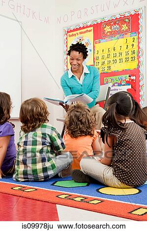 Stock Photograph - Teacher reading to children. Fotosearch