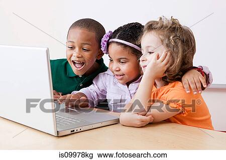 Three children looking at the laptop together View Large Photo Image Stock Image - Three children looking at the laptop together. Fotosearch