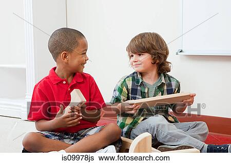 Two boys with building blocks View Large Photo Image Stock Photograph - Two boys with building blocks. Fotosearch