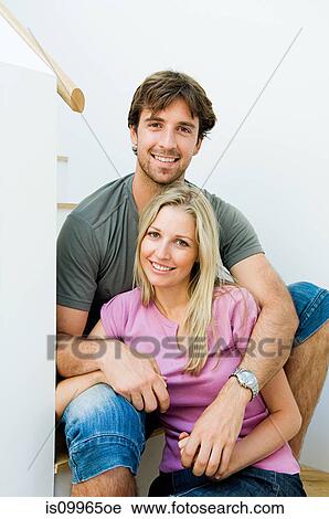 Young couple smiling on staircase View Large Photo Image Stock Image - Young couple smiling on staircase. Fotosearch