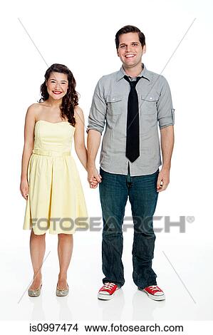 Young couple standing against white background View Large Photo Image Picture - Young couple standing against white background. Fotosearch