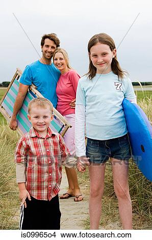 Young family on beach, portrait View Large Photo Image Picture - Young family on beach, portrait. Fotosearch