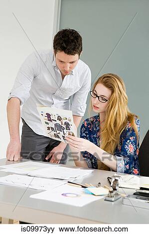 Young fashion designers looking at fashion samples View Large Photo Image Stock Photo - Young fashion designers looking at fashion samples. Fotosearch