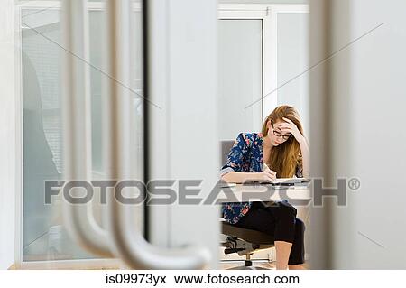Young female fashion designer working at desk View Large Photo Image Stock Photo - Young female fashion designer working at desk. Fotosearch