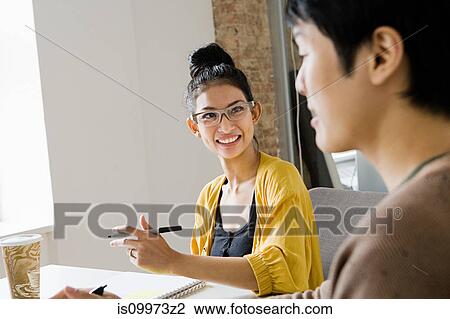 Young man and woman in office View Large Photo Image Stock Image - Young man and woman in office. Fotosearch