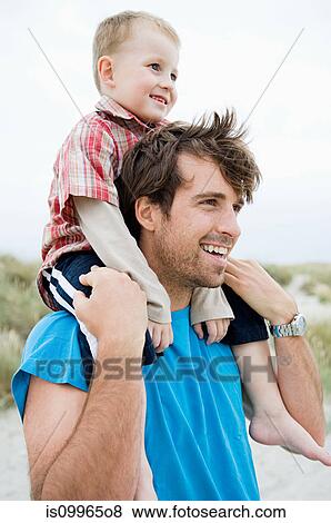 Young man carrying boy on shoulders View Large Photo Image Stock Photo - Young man carrying boy on shoulders. Fotosearch