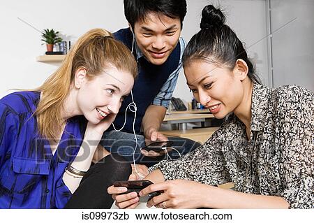 Young women and man listening to mp3 player View Large Photo Image Stock Image - Young women and man listening to mp3 player. Fotosearch