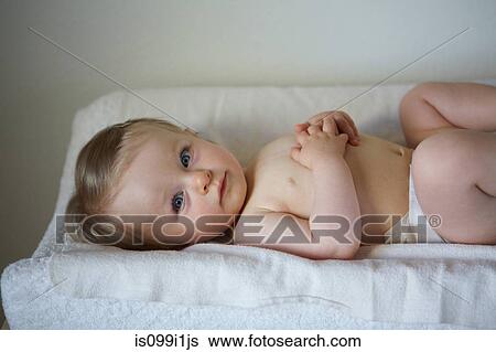 Stock Photograph - Baby girl lying on blanket. Fotosearch