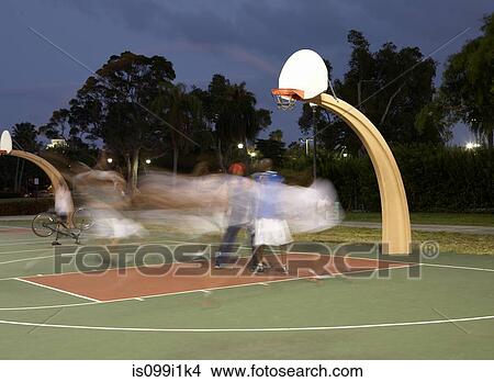 Picture - Basketball players at night, blurred motion. Fotosearch