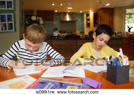 Boys doing homework at table View Large Photo Image Stock Photo - Boys doing homework at table. Fotosearch