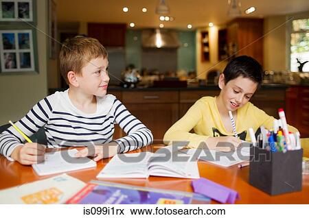Boys doing homework at table View Large Photo Image Stock Photo - Boys doing homework at table. Fotosearch