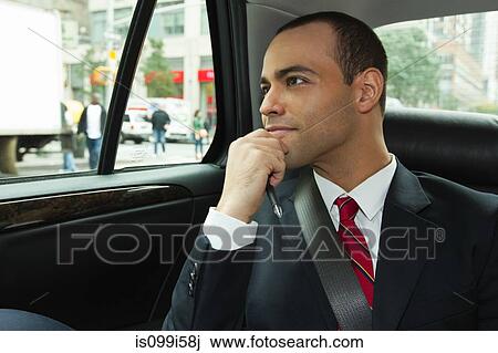 Businessman looking out of window in car View Large Photo Image Stock Image - Businessman looking out of window in car. Fotosearch
