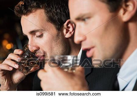 Businessmen drinking shots in bar View Large Photo Image Stock Image - Businessmen drinking shots in bar. Fotosearch