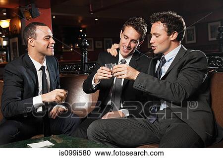 Businessmen drinking together in bar View Large Photo Image Stock Image - Businessmen drinking together in bar. Fotosearch
