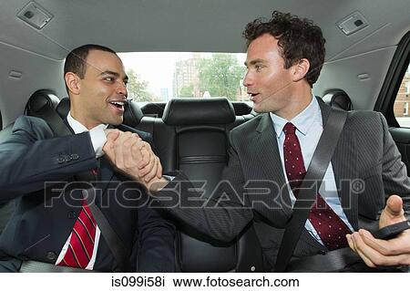 Businessmen shaking hands in car View Large Photo Image Stock Image - Businessmen shaking hands in car. Fotosearch