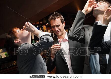 Businesspeople drinking at a bar View Large Photo Image Stock Photo - Businesspeople drinking at a bar. Fotosearch