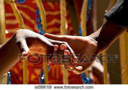 Stock Photo - Close up of couple holding hands. Fotosearch