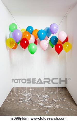 Picture - Colorful balloons in a room. Fotosearch