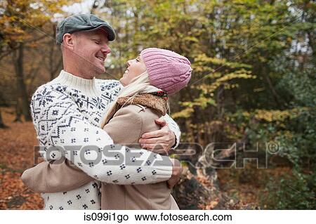 Couple hugging in park View Large Photo Image Picture - Couple hugging in park. Fotosearch